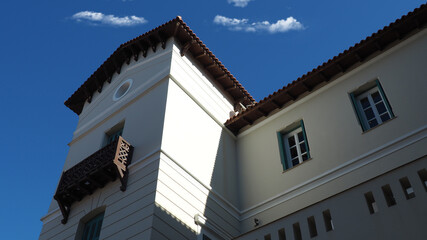 Beautiful public neoclassic tower building in Kifisia district on a blue cloudy sky, North Athens, Attica, Greece