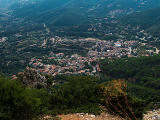 Fototapeta premium Aerial View of village Villagrande Strisaili with limestone rocks, mountains and green forest vegetation. Summer sunny day. Province of Nuoro, Sardinia, Italy, Europe