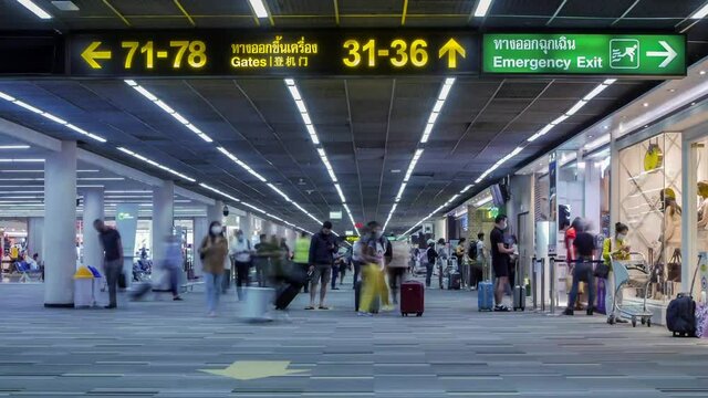 Timelapse landscape view inside the airport terminal with many passenger under covid19 corona virus crisis happens in Thailand