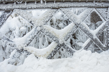 Iced bridge, cast iron railings. Close-up. Frost, ice, cold concept