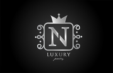 N monogram silver metal alphabet letter logo icon. Creative design with king crown for luxury company and business