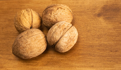  walnuts in shells lie in a shopping cart against the background of a knitted bag. Background from walnuts. Healthy walnuts. Natural walnut background texture pattern Abstract walnuts