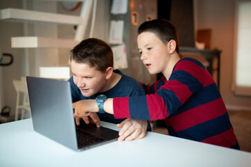 boy looking at a laptop with a worried and confused look