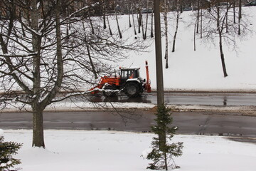 tractor cleans snow