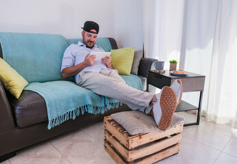Fototapeta premium Young man having video call with tablet at home - Social distance and home isolated for coronavirus outbreak