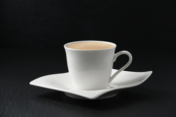 White cup of coffee on black background