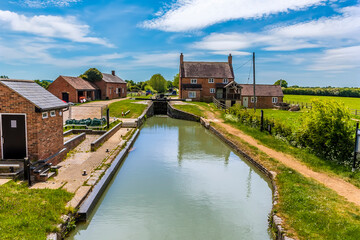 Naklejka na ściany i meble A view towards a flight of locks on the Oxford Canal at Napton, Warwickshire in summertime