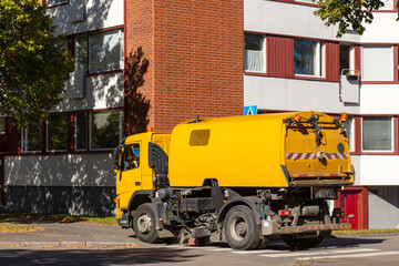 yellow street sweeper car at work