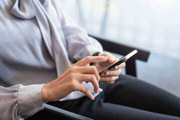 Business woman with break time and using favorite smartphone at the office.
