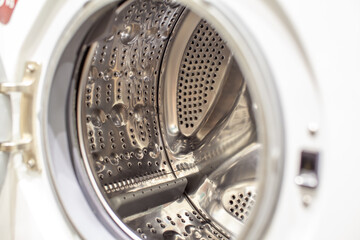 The washing machine drum is dry and clean close-up. Washer