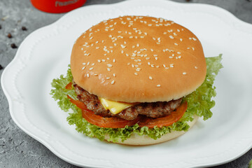 hamburger with fries and salad on the plate