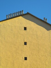 Three small window frames row on concrete wall building metaphor of social isolation caused by pandemic crisis