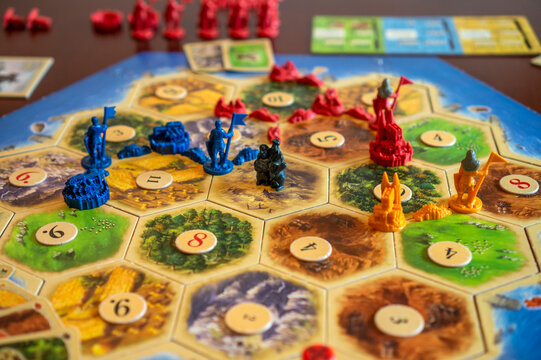 Balogunyom / Hungary - 01.04.2019: Board game party Settlers of Catan, popular board game. Players are scrambling the area to get more resources and victory points.
