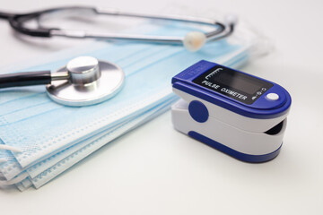 Medical concept. pulse oximeter, stethoscope and face masks. Selective focus