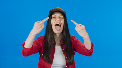 Brunette woman in hat showing middle finger, rude sign of disrespect, making a fuck gesture with...