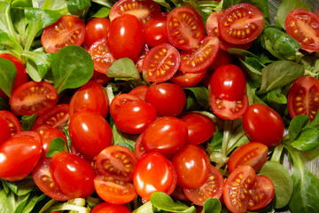 Cherry tomato background with green . Close up