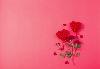 red hearts and roses on pink paper background