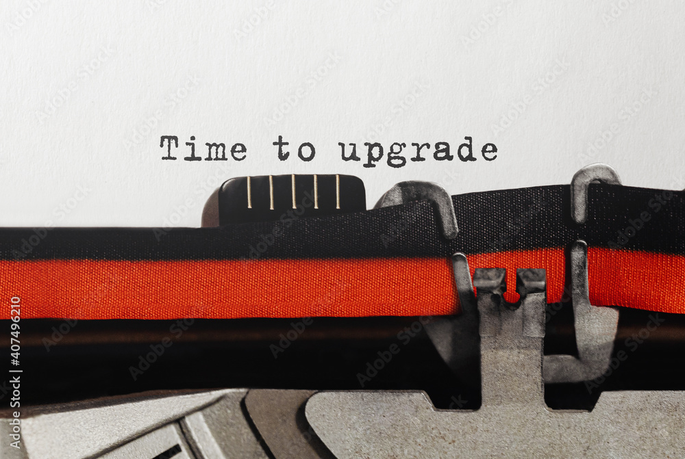Poster text time to upgrade typed on retro typewriter