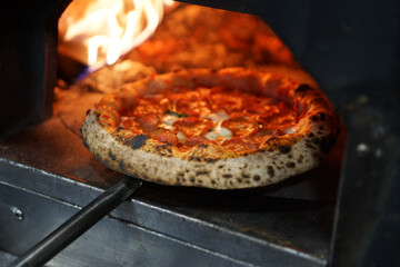 Neapolitan pepperoni pizza in wood-fired oven