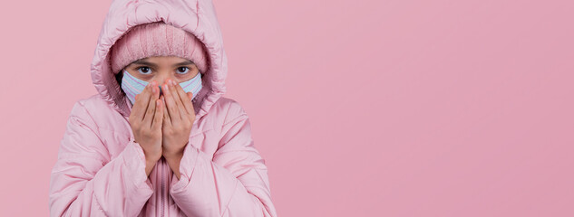 Coronavirus, Covid-19. funny girl In Protective Face Mask Coughing In Elbow Standing On pink Studio Background, Wearing Winter Clothes. Corona Virus And Flu Epidemic Season. Copy Space. panorama