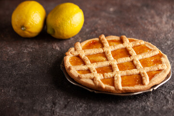 Lemon tart with copy space. Lemon shortcrust pie on concrete table