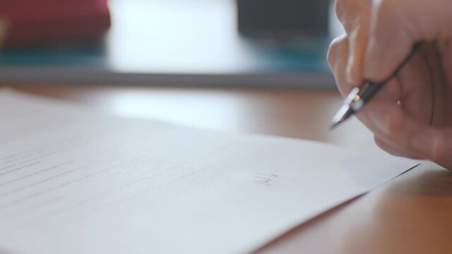 Content contains sensitive information such as signatures, credit card numbers, email addresses, isolated license plates, etc.Close -up a business man sign the agreement.