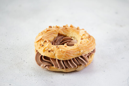 Classic French dessert Paris Brest with chocolate cream