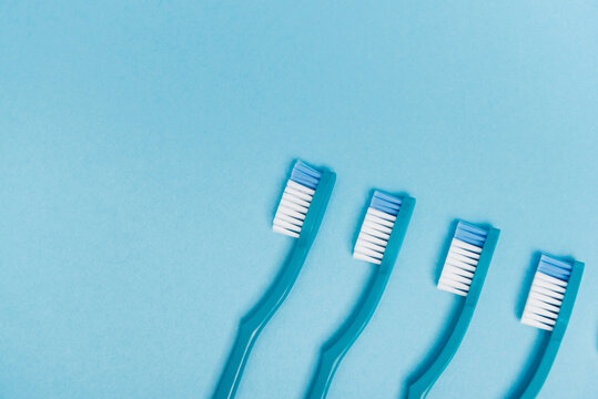 Top view of toothbrushes on blue background