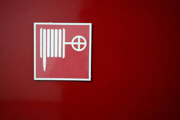 fire hydrant sign on the red wall background