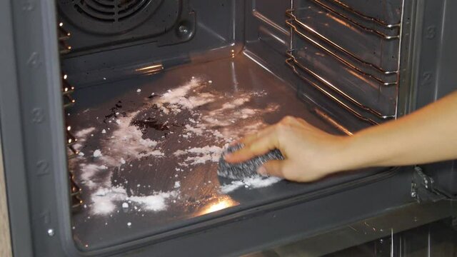 The Process Of Cleaning The Oven With Baking Soda.