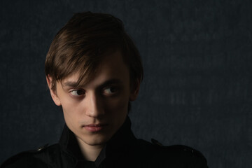 Portrait image of a young man in dark clothes