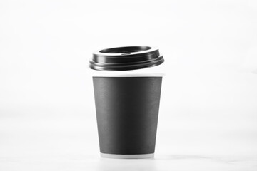 Paper cup of coffee on white background