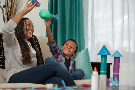 African American Mother and Child Learn About Science, Space and Rockets in Remote Learning