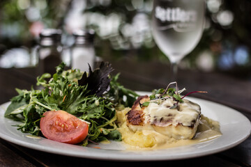 Fresh fish on mashed potatoes with cream and salad