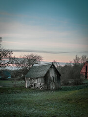 on the plot of land stands an ancient crooked wooden house