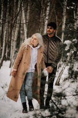 couple walking in winter forest