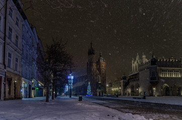 Winter in Cracow, snowy night near St. Mary's Church in Cracow marketplace