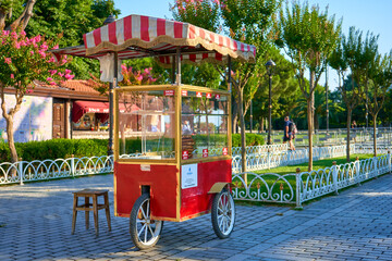 Man sale traditional Turkish bagel simit from cart on the summer Istanbul street