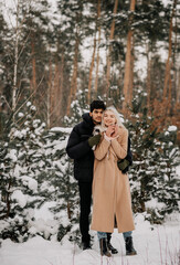 couple walking in winter forest