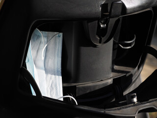Protective face mask in the trunk of the scooter moped.
