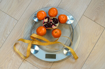 Bathroom scales and fruits. Fitness for weight loss.