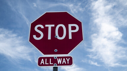 Stop sign on a cloudy background
