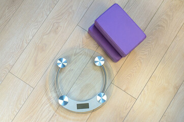 Bathroom scales and yoga bricks. Fitness for weight loss.
