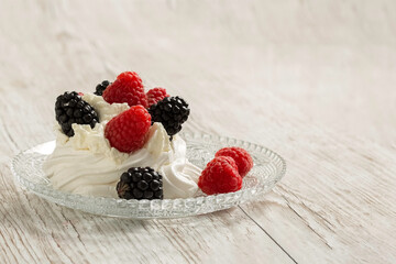 Pavlova cake on a glass plate. Festive dessert. Copy space. 