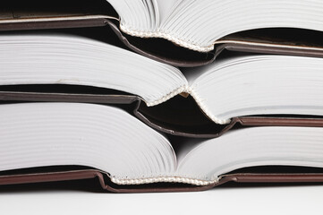 Close-up of the hardback of a thick book on a gray background. Reading and libraries
