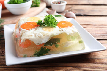 Delicious fish aspic served on wooden table, closeup