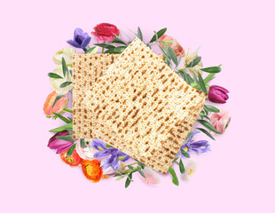 Tasty matzos and flowers on pink background, flat lay. Passover (Pesach) celebration