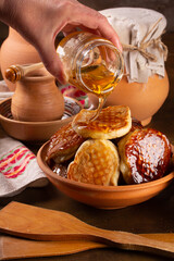 Fresh delicious pancakes lie in a ceramic dish