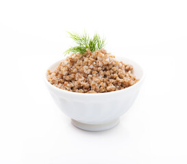 Boiled buckwheat with dill in a plate isolated on a white