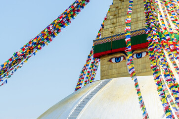 Close up on Buddha eyes on top of the white stupa at Boudhanath, Kathmandu, Nepal